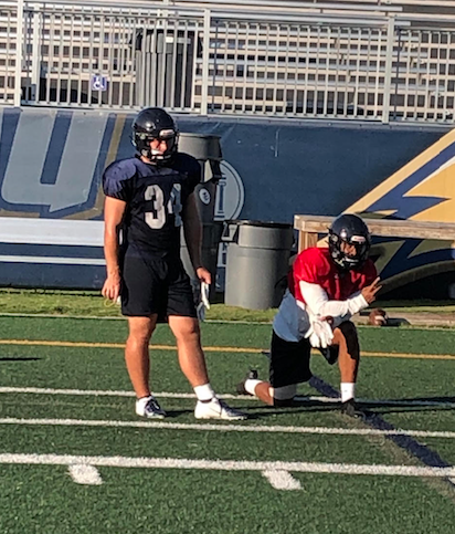 Connor Showalter and Octavious Ross watching a drill during practice. 