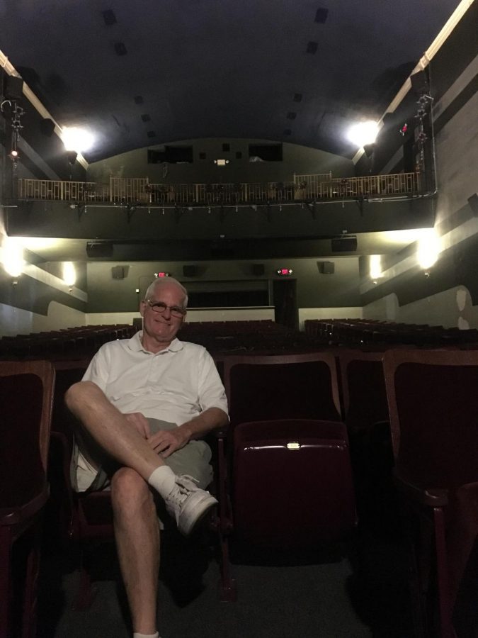 Wayne Alan, World Champion Magician, sitting inside the historic North Theater.