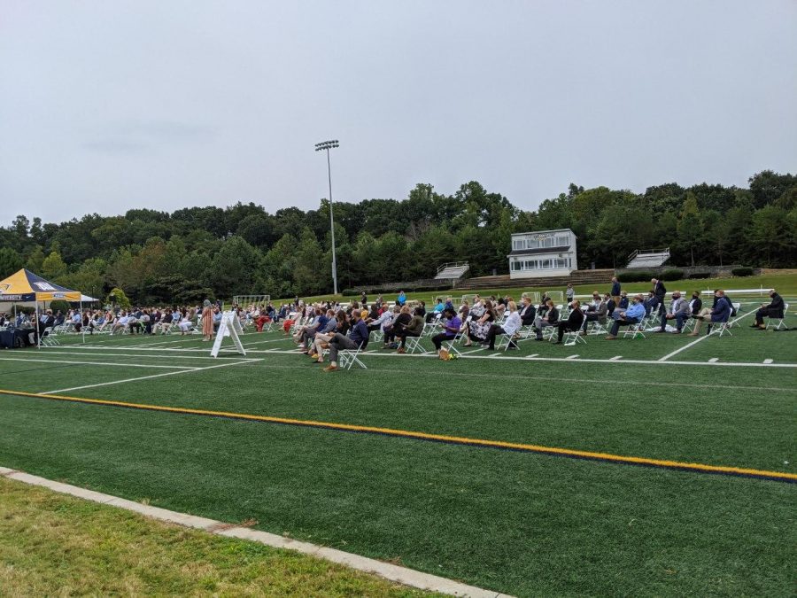 Students sit, socially distanced, on Daly Field for the pinning ceremony. 