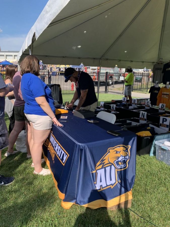 Dillon Weaver sells Averett merchandise at a football game