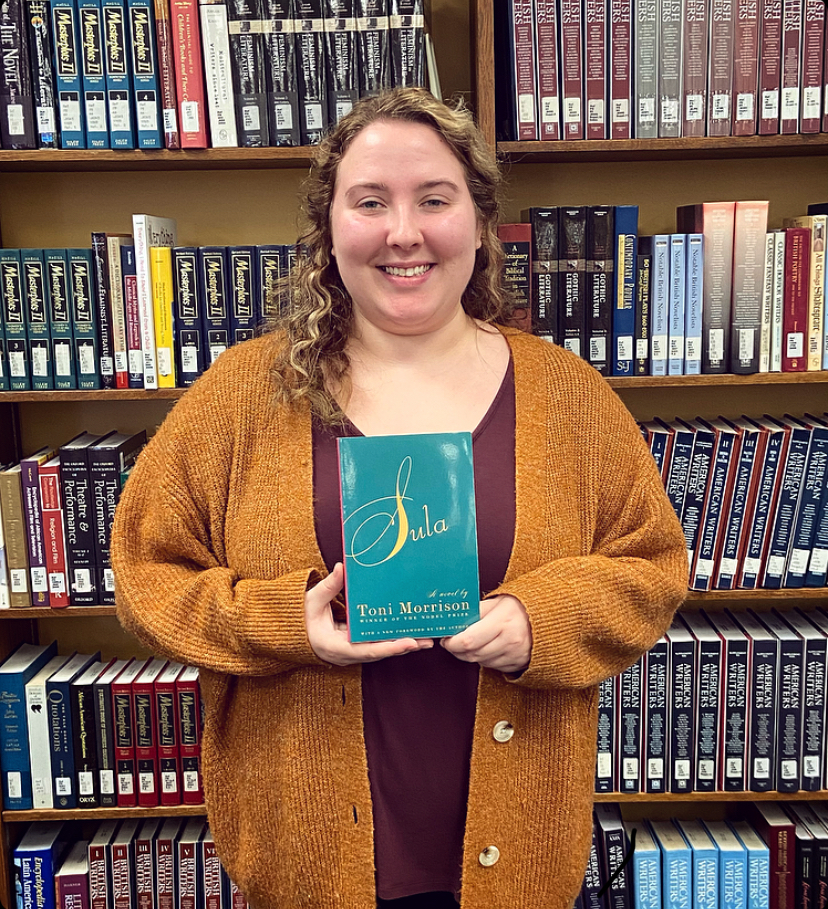 Library Operations Coordinator, Jessie Ross, holding Februarys chosen title, Sulla by Toni Morrison